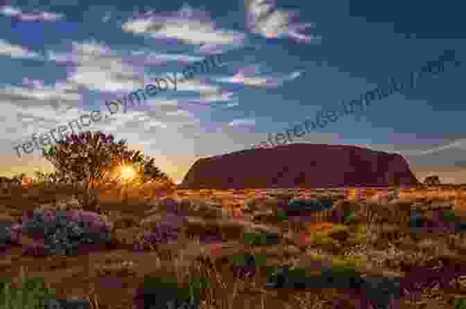 A Helicopter Soars Over The Rugged Red Rock Formations Of Uluru, A Sacred Aboriginal Site. Australia: A 4D (The Seven Continents)